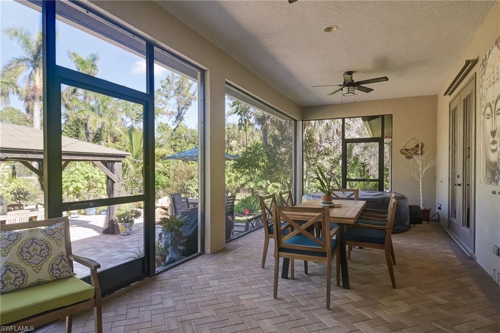 6350 Parkers Hammock Road Naples, FL 34112 - Photo 26 of 49 a dining room with furniture and wooden floor