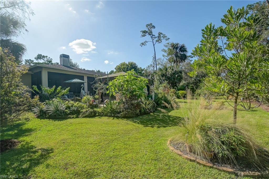 6350 Parkers Hammock Road Naples, FL 34112 - Photo 32 of 49 a view of a garden