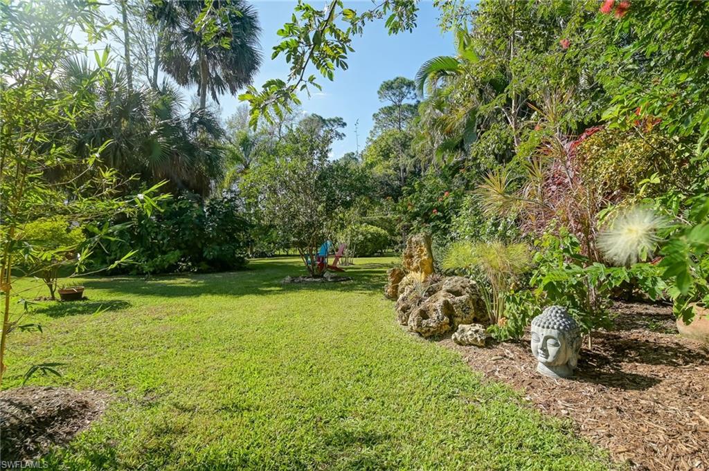 6350 Parkers Hammock Road Naples, FL 34112 - Photo 33 of 49 a backyard of a house with lots of green space