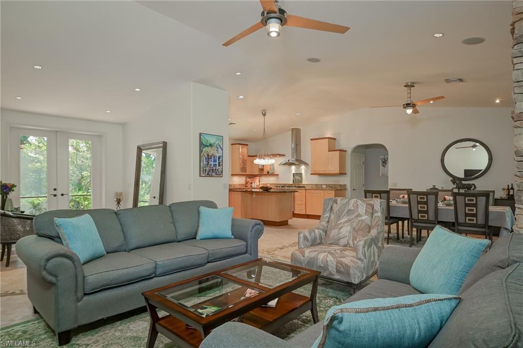 6350 Parkers Hammock Road Naples, FL 34112 - Photo 48 of 49 a living room with furniture kitchen and a chandelier