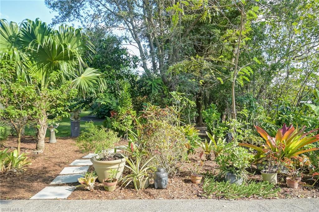 6350 Parkers Hammock Road Naples, FL 34112 - Photo 39 of 49 a view of a backyard with sitting area