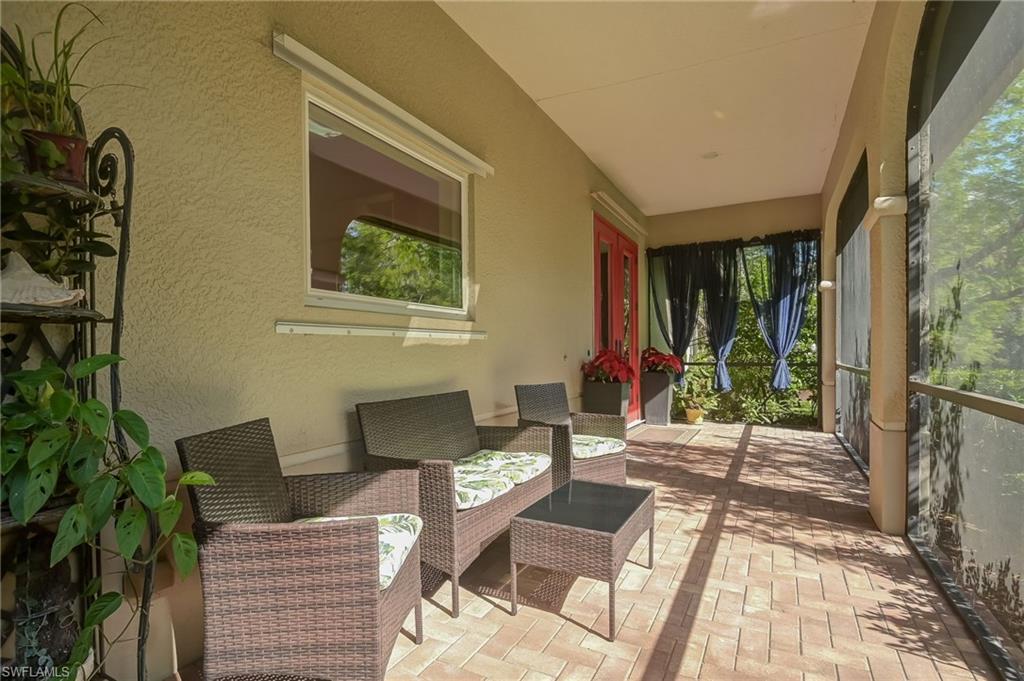 6350 Parkers Hammock Road Naples, FL 34112 - Photo 42 of 49 a view of a patio with table and chairs and potted plants