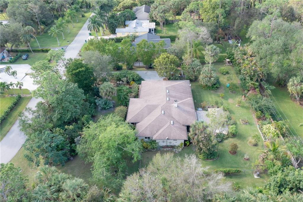 6350 Parkers Hammock Road Naples, FL 34112 - Photo 46 of 49 an aerial view of residential house with outdoor space and trees all around