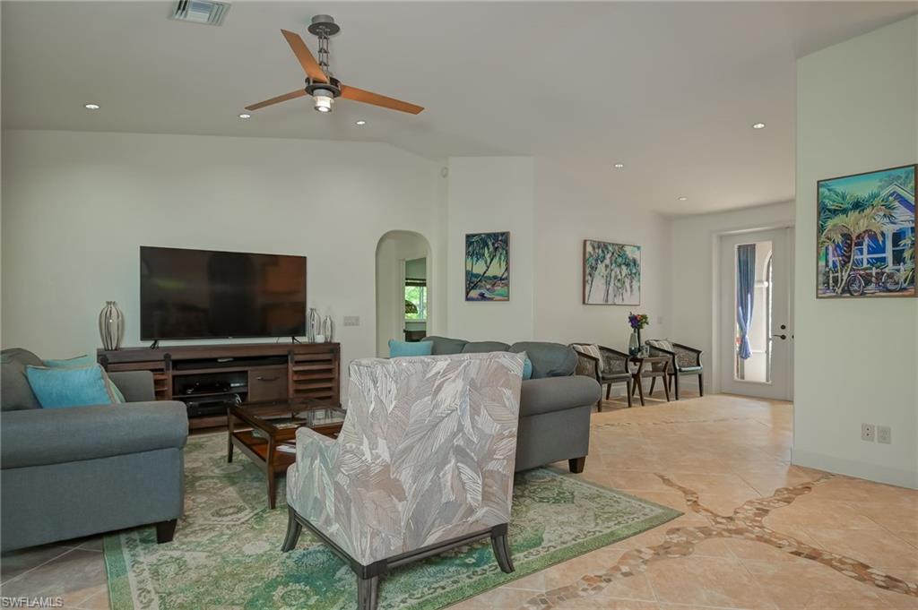 6350 Parkers Hammock Road Naples, FL 34112 - Photo 5 of 49 a living room with furniture and a flat screen tv