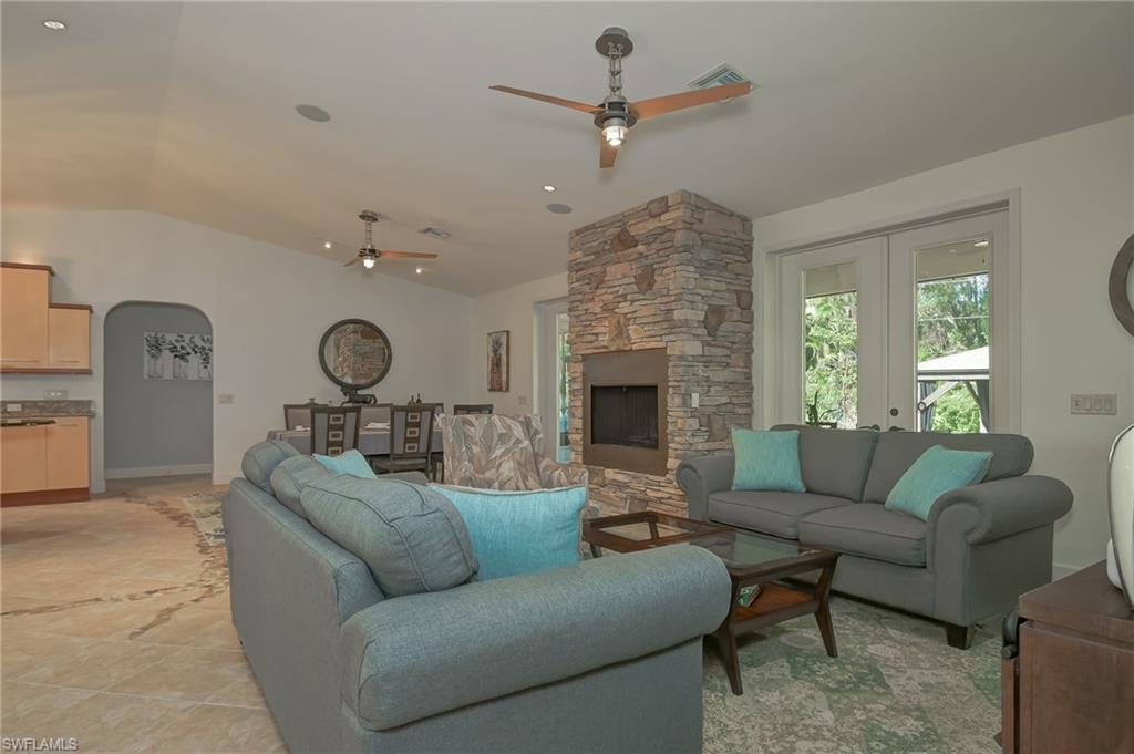 6350 Parkers Hammock Road Naples, FL 34112 - Photo 49 of 49 a living room with furniture and a fireplace