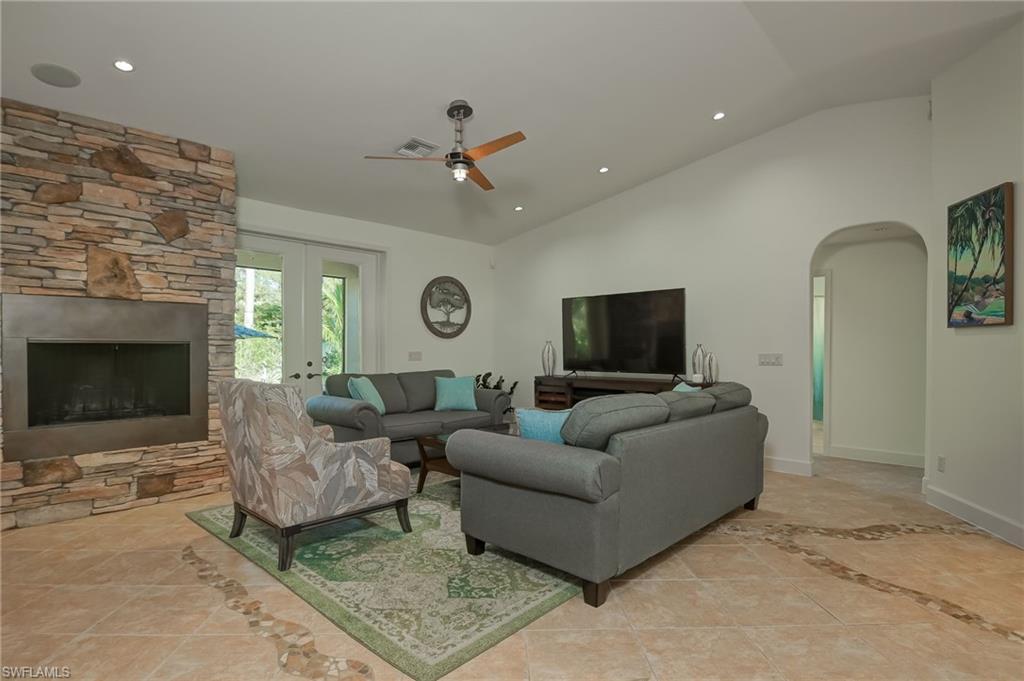 6350 Parkers Hammock Road Naples, FL 34112 - Photo 7 of 49 a living room with furniture and a fireplace