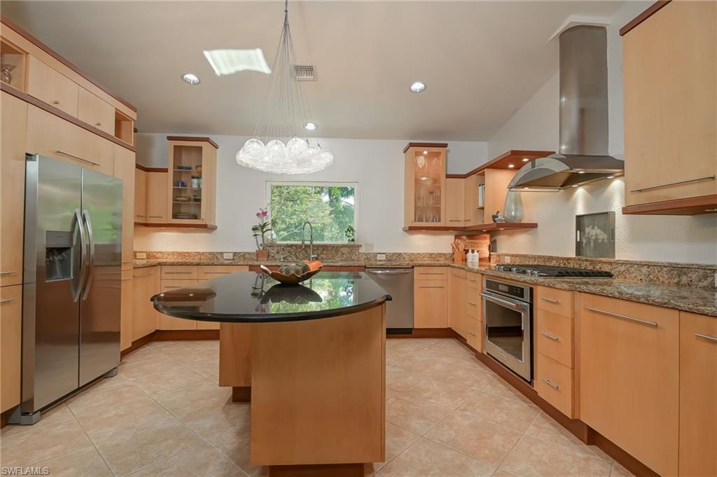 6350 Parkers Hammock Road Naples, FL 34112 - Photo 8 of 49 a kitchen with stainless steel appliances granite countertop a sink a stove and a refrigerator