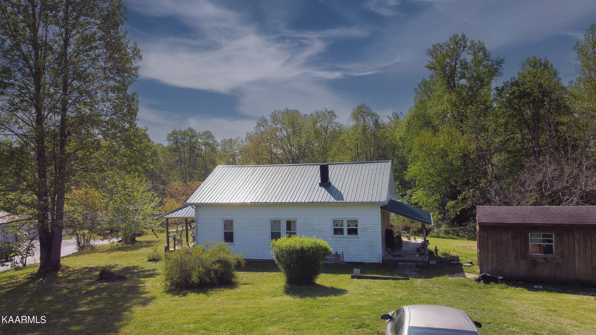 342 Raines Road Wartburg, TN 37887 - Photo 5 of 6 a view of a house with a backyard and a garden