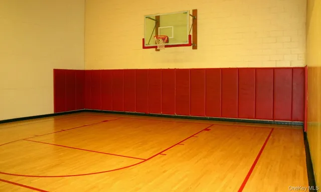 a view of a room with wooden floor and cabinet