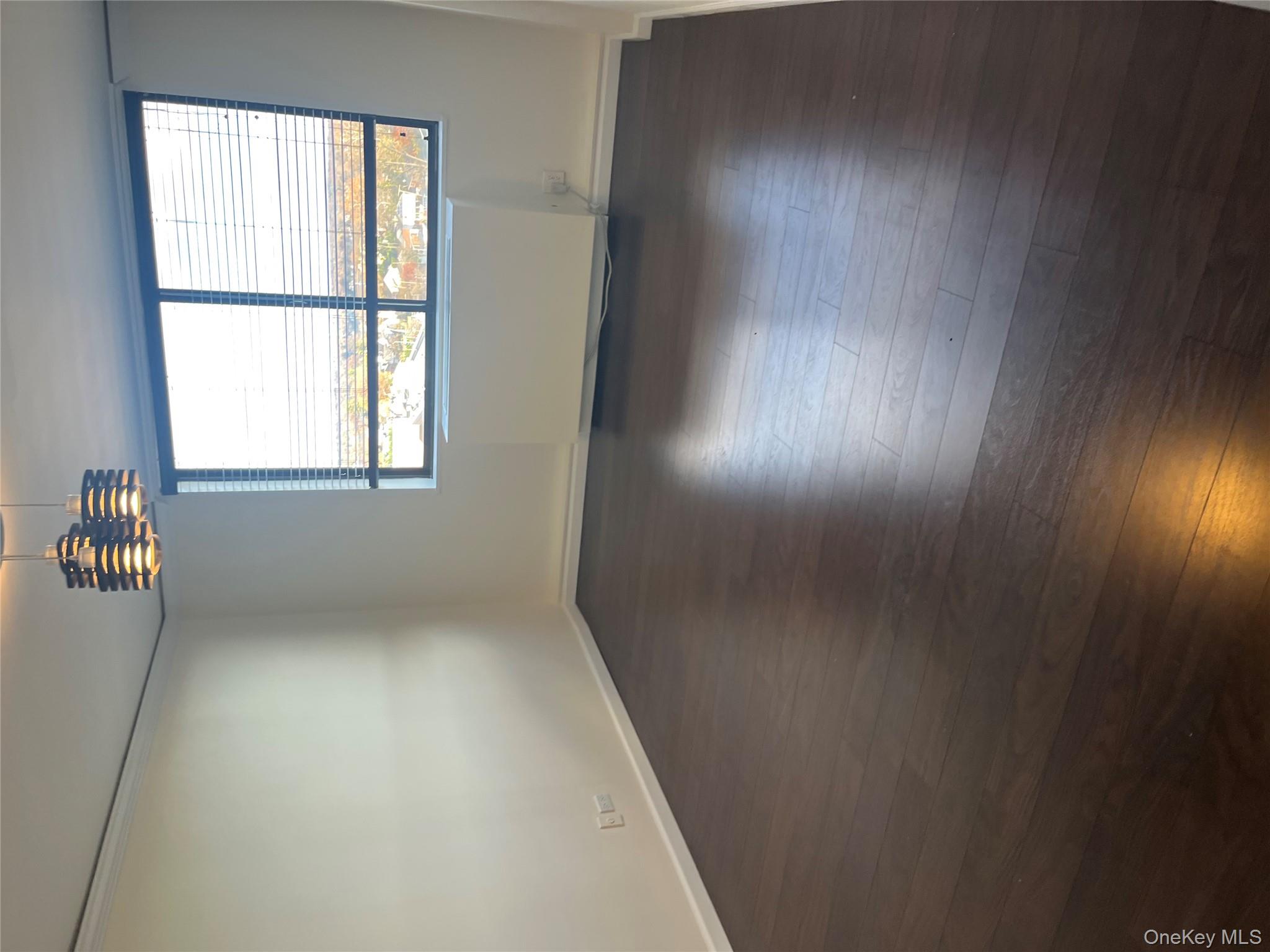 2 Bay Club Drive, Unit 6D Queens, NY 11360 - Photo 6 of 17 an empty room with wooden floor and windows
