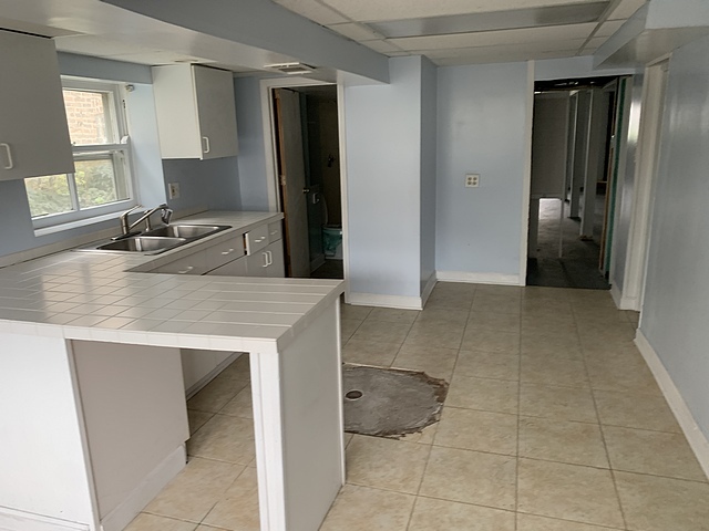 2309 Ridgeland Avenue Berwyn, IL 60402 - Photo 14 of 15 a kitchen with a sink cabinets and a refrigerator