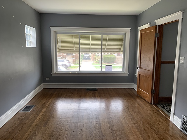 2309 Ridgeland Avenue Berwyn, IL 60402 - Photo 3 of 15 an empty room with wooden floor and windows