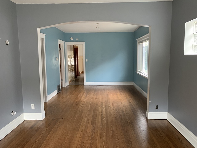 2309 Ridgeland Avenue Berwyn, IL 60402 - Photo 4 of 15 an empty room with wooden floor and windows