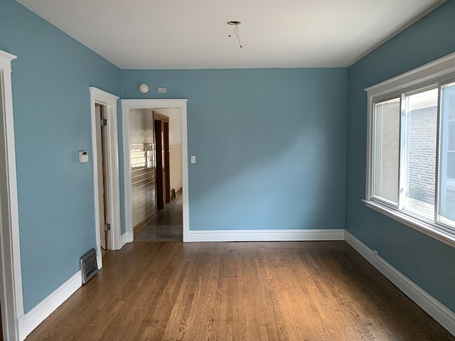 2309 Ridgeland Avenue Berwyn, IL 60402 - Photo 5 of 15 an empty room with wooden floor and windows