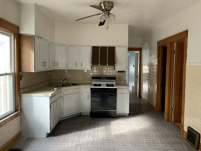 2309 Ridgeland Avenue Berwyn, IL 60402 - Photo 6 of 15 a kitchen with stainless steel appliances granite countertop a stove a refrigerator and a stove top oven