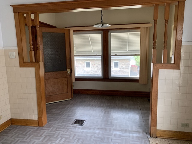 2309 Ridgeland Avenue Berwyn, IL 60402 - Photo 7 of 15 a view of an empty room with a window and wooden floor