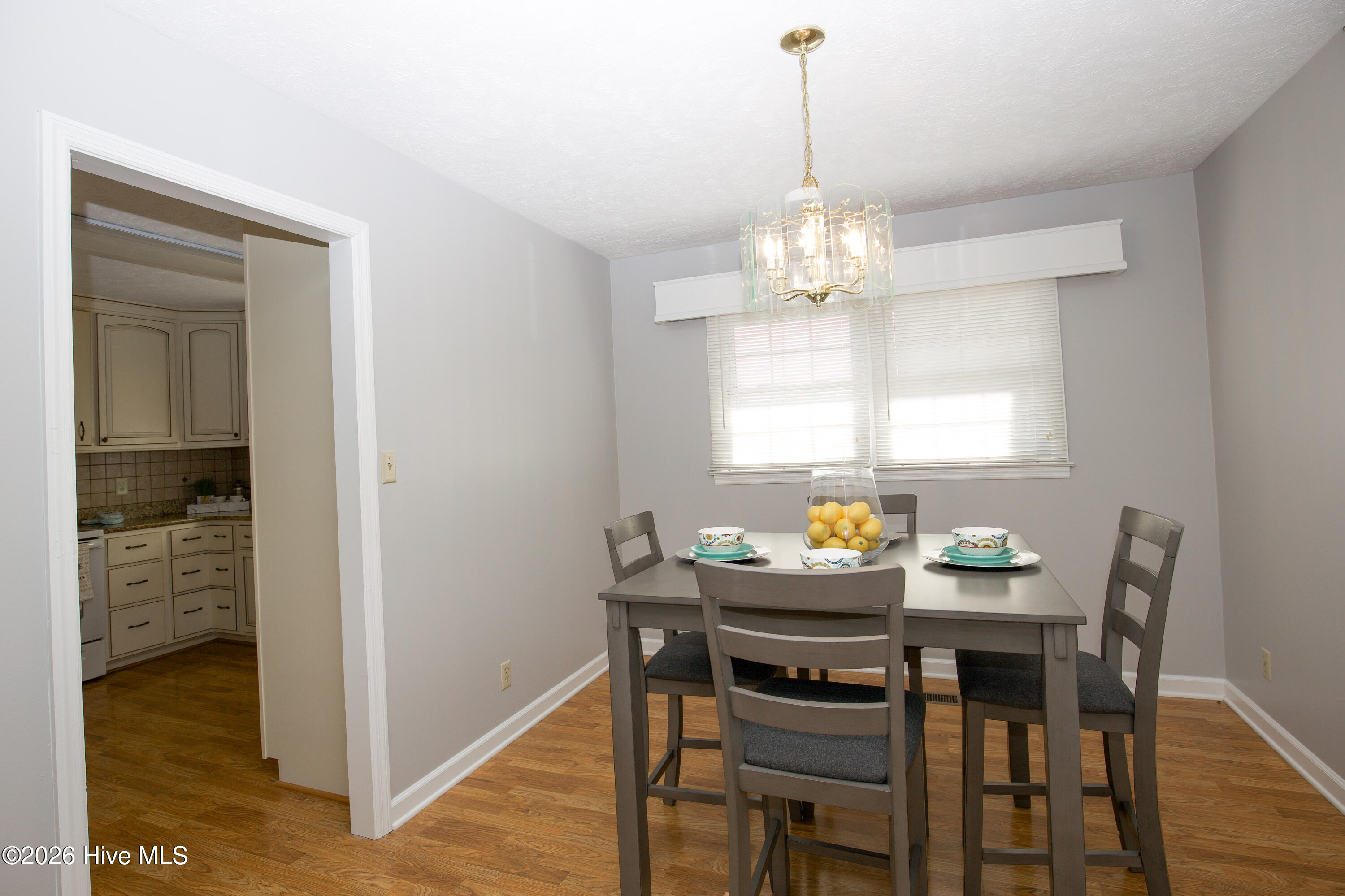 5068 Lobelia Road Vass, NC 28394 - Photo 15 of 70 This charming dining area sits just off the kitchen, offering a seamless transition for serving meals or entertaining. The space is bathed in natural light from the large window, while a stylish chandelier adds a touch of elegance. Neutral wall colors and wood-look flooring create a clean, modern backdrop ready for your personal style. Whether it’s daily dinners or weekend brunches, this cozy and functional area is the perfect setting. The proximity to the kitchen keeps everything within reach and enhances the home's overall flow and convenience.