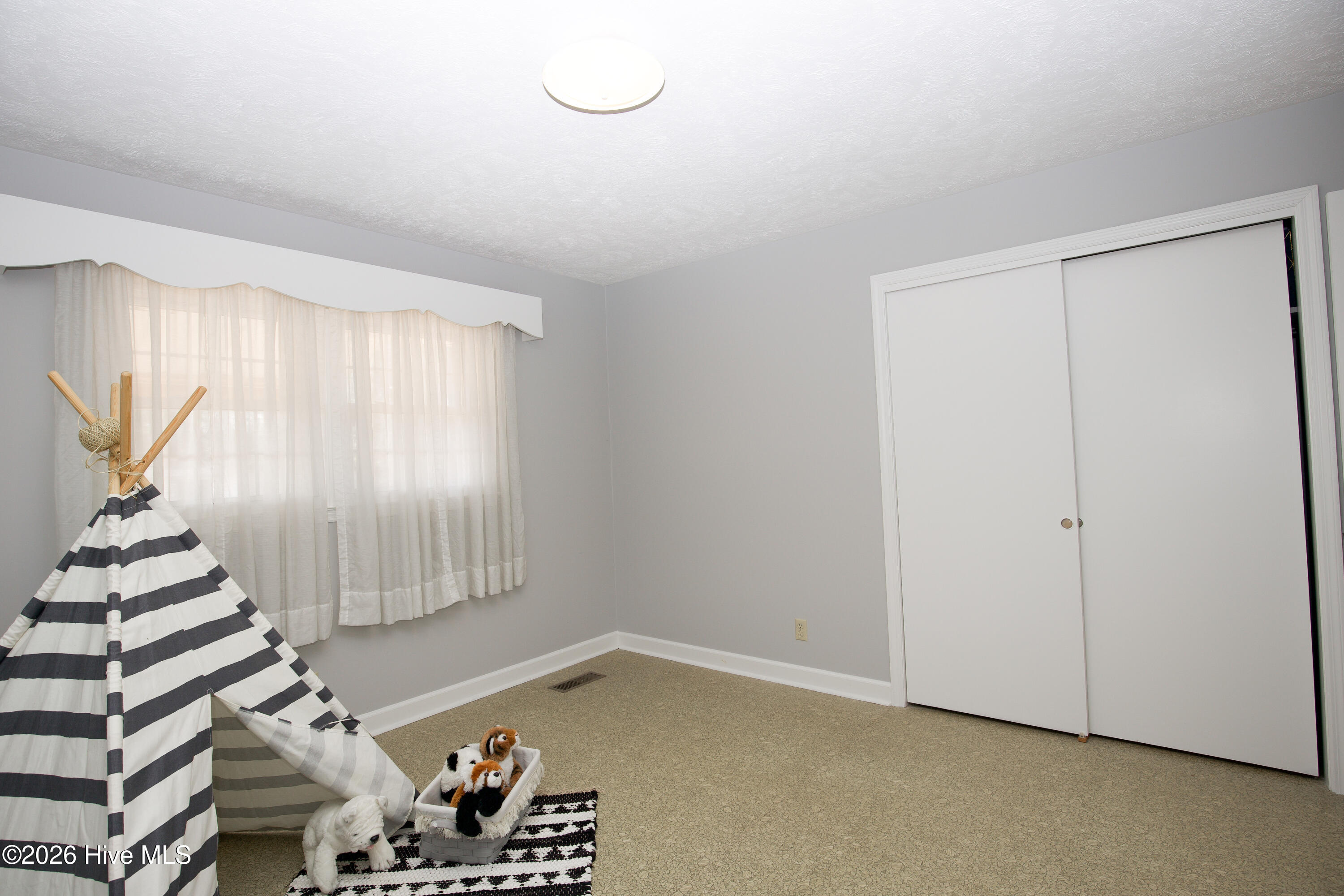 5068 Lobelia Road Vass, NC 28394 - Photo 40 of 70 Another view of the flex room, showcasing a spacious closet and large window for natural light. This versatile space is not listed as a bedroom per NCREC advertising guidelines, as the septic permit is for a 3-bedroom system.