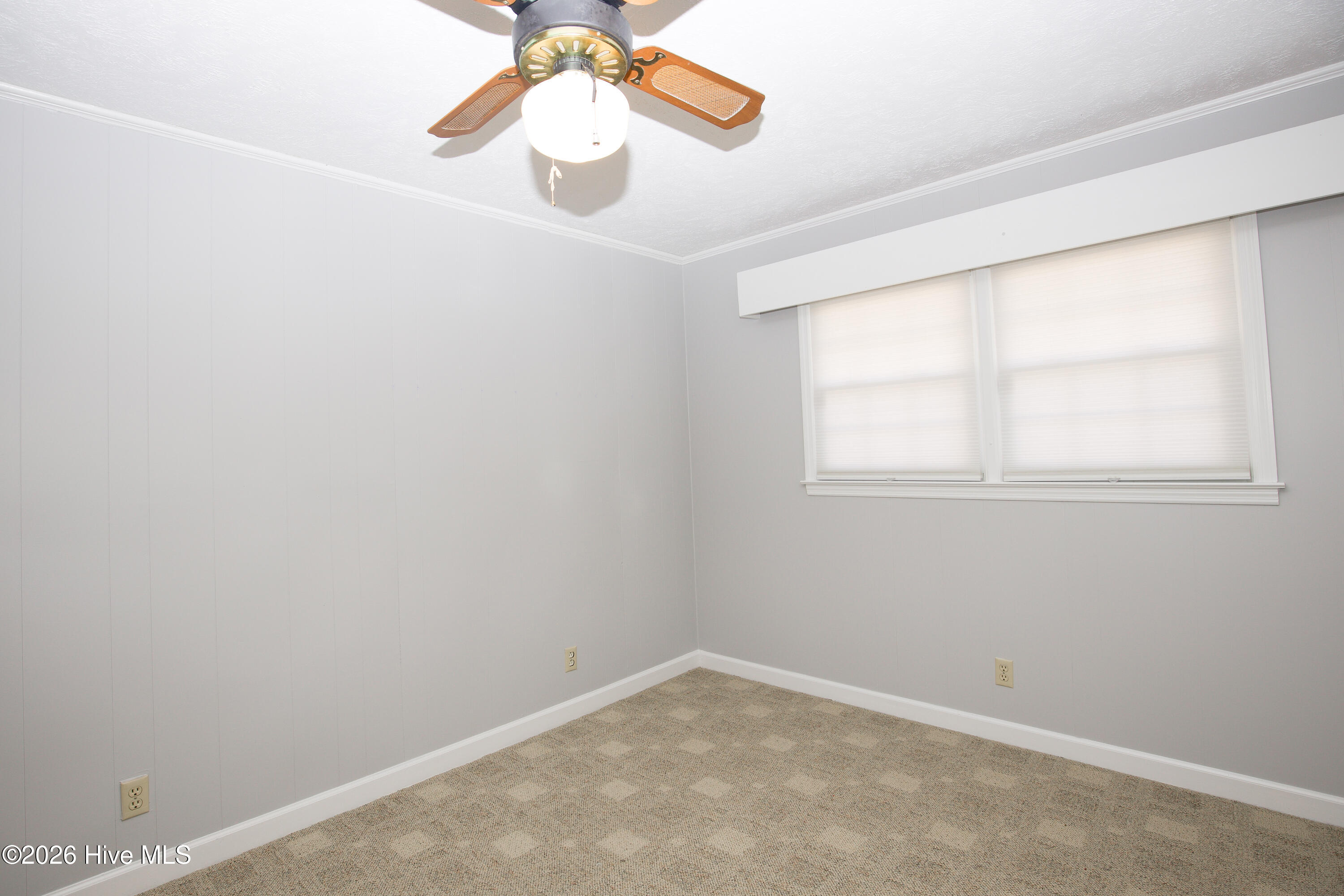 5068 Lobelia Road Vass, NC 28394 - Photo 43 of 70 Bedroom #3 with front-facing windows bringing in natural light through stylish pleated blinds. Neutral walls and carpet offer a move-in-ready backdrop. Ceiling fan with light fixture adds comfort and charm to this versatile space.