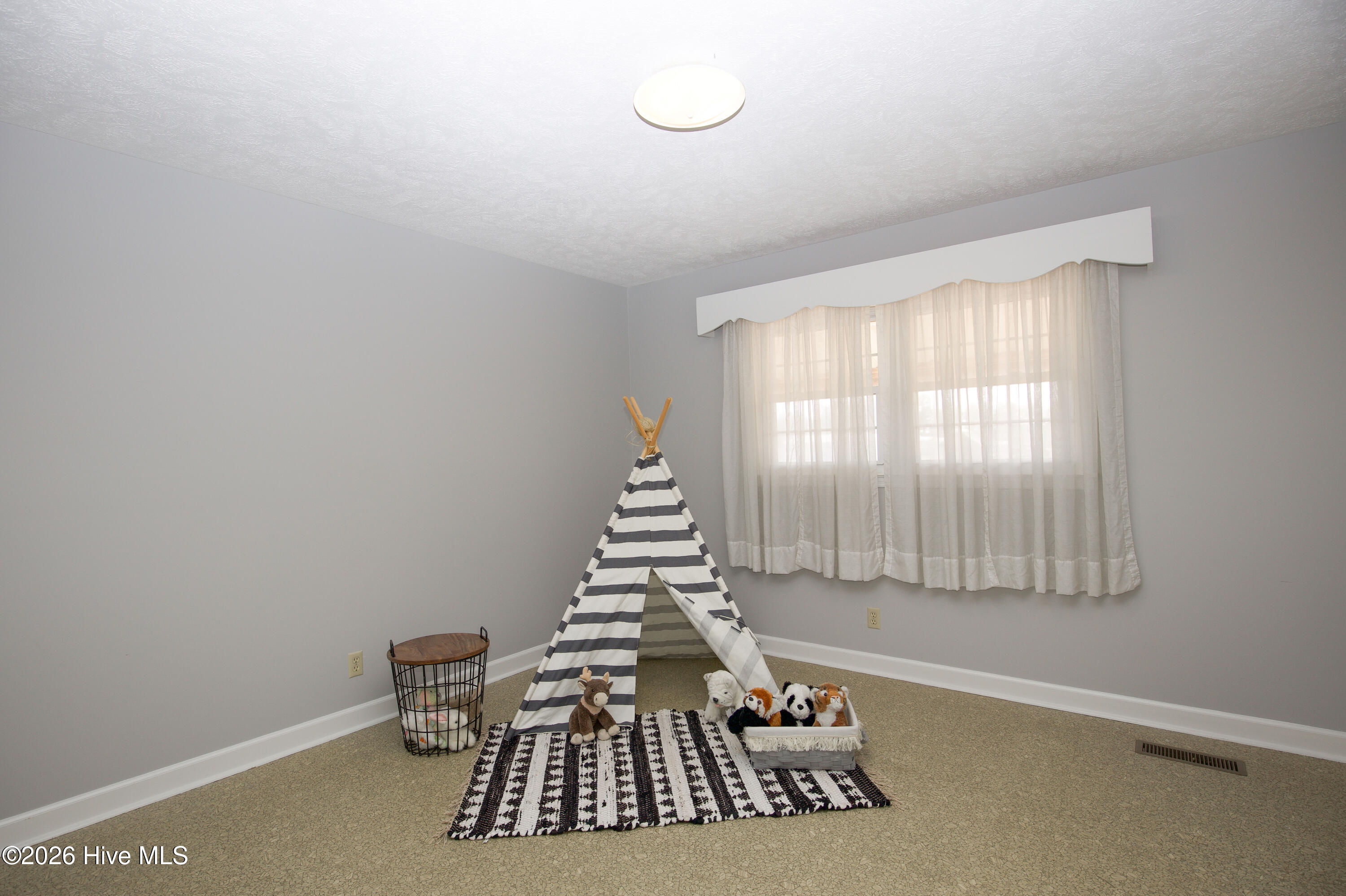 5068 Lobelia Road Vass, NC 28394 - Photo 47 of 70 Versatile flex room featuring a large window for natural light and a spacious layout, perfect for a playroom, office, or guest space. Includes a closet for extra storage.