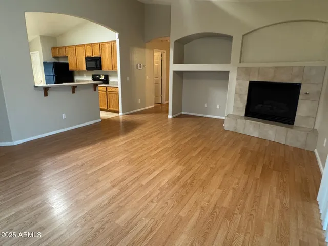 a kitchen with a refrigerator and cabinets