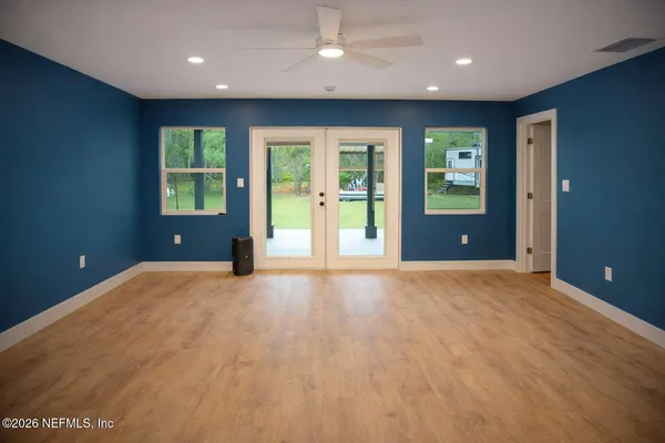 an empty room with windows and closet