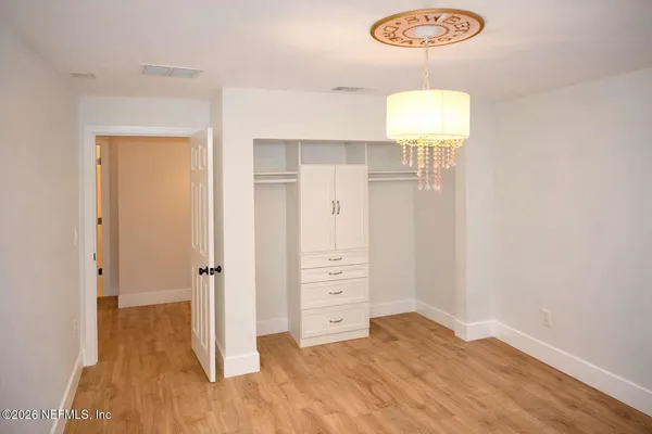 a view of a room with wooden floor and window