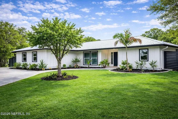 a front view of house with yard and green space