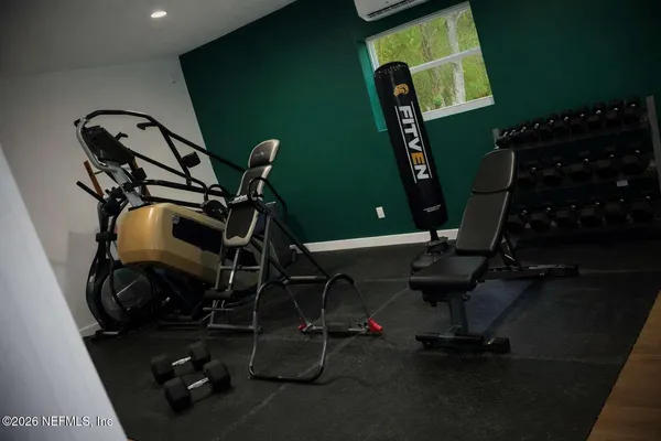 a room with gym equipment and a flat screen tv