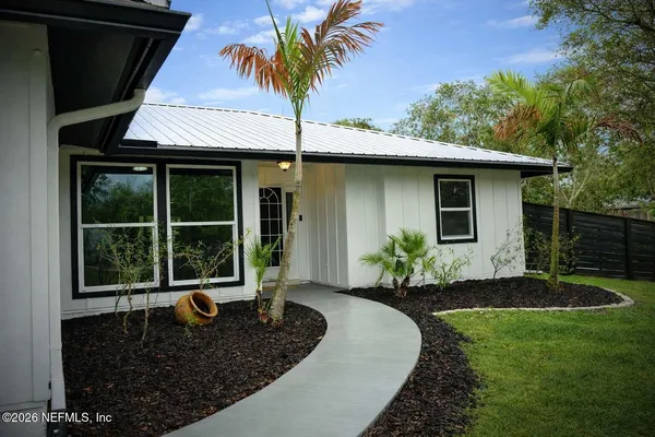 a front view of a house with garden