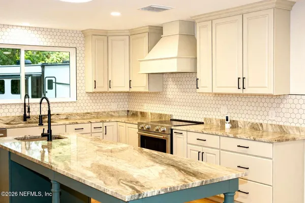 a kitchen with stainless steel appliances granite countertop a sink and cabinets