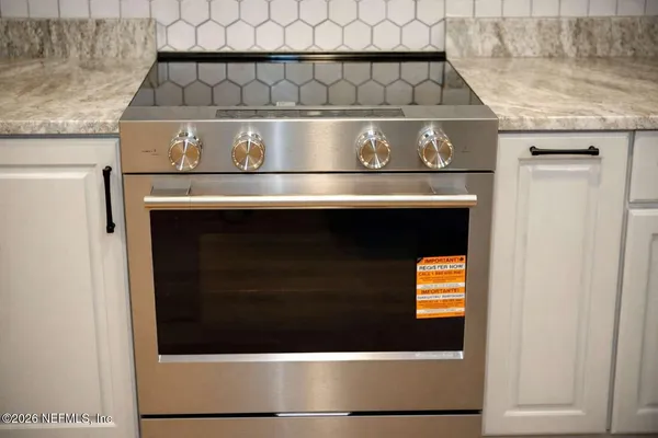 a stove top oven sitting inside of a kitchen