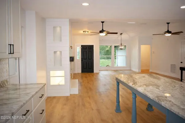a view of a kitchen cabinets and wooden floor