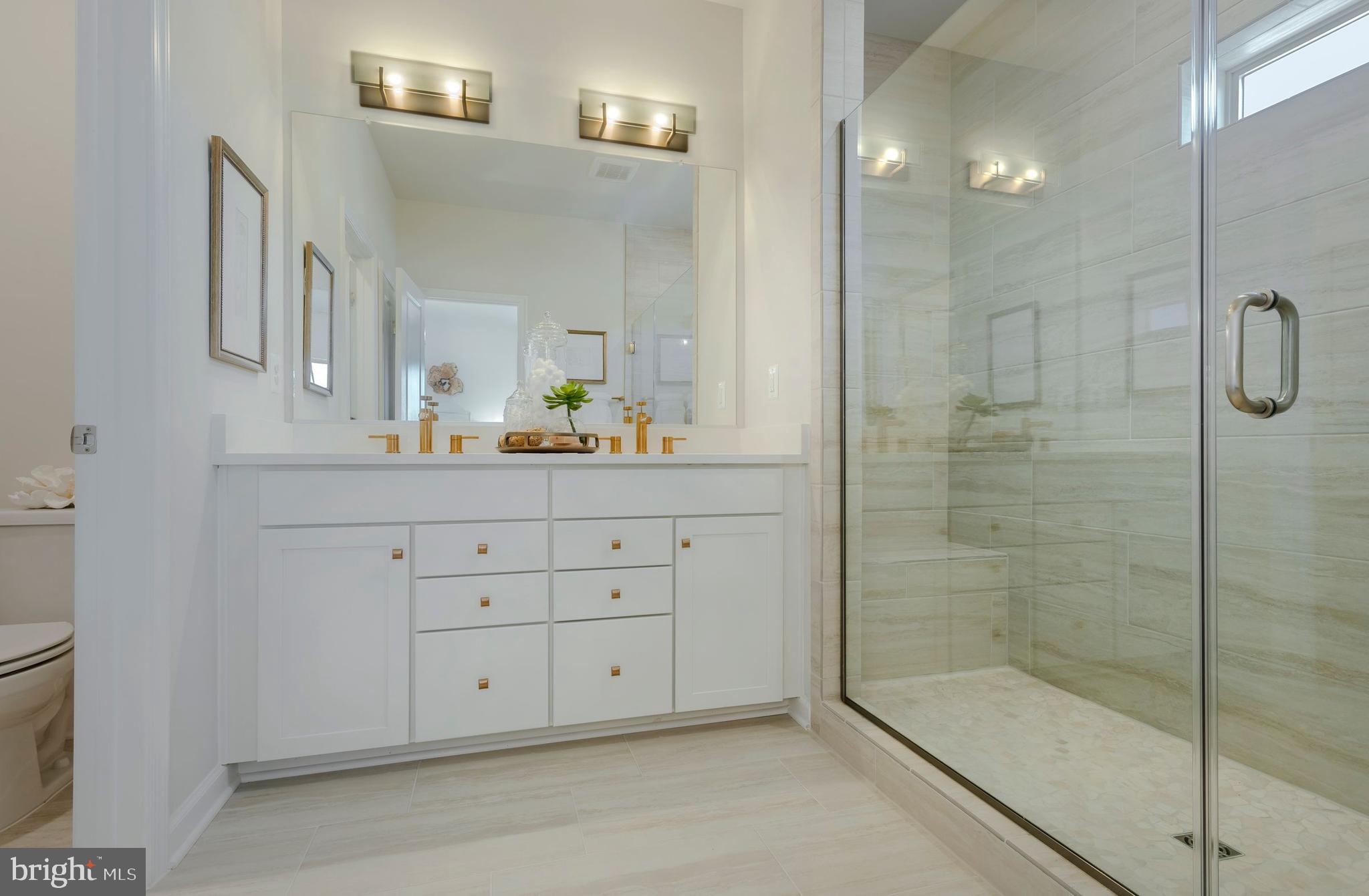 12109 Spirit Avenue Laurel, MD 20708 - Photo 6 of 33 a bathroom with a shower sink and mirror