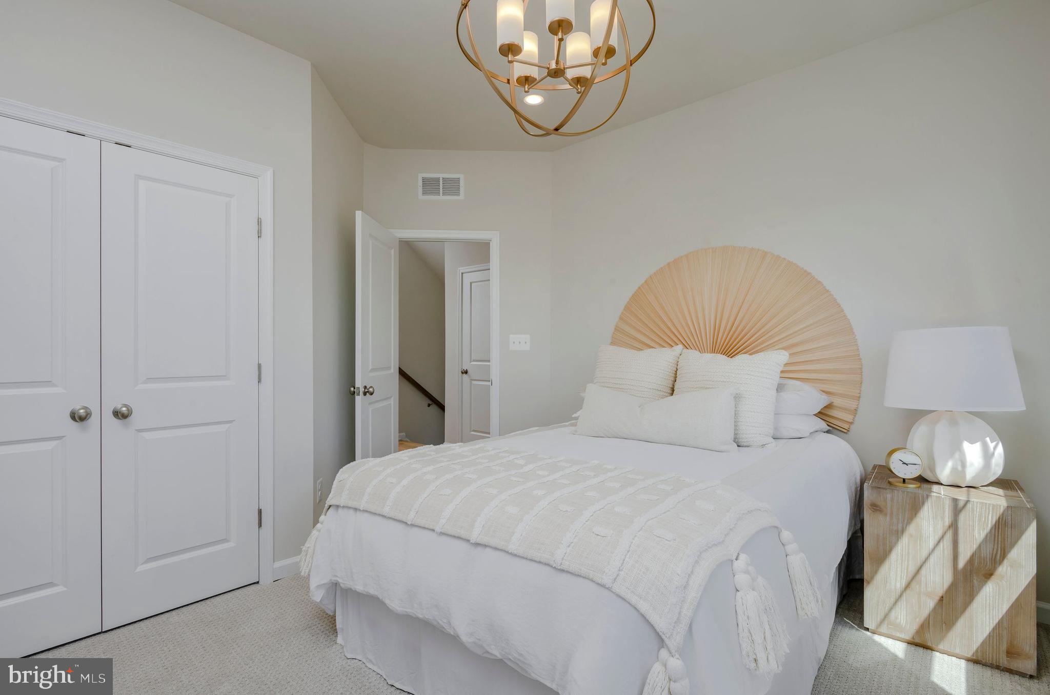 12109 Spirit Avenue Laurel, MD 20708 - Photo 10 of 33 a bedroom with a bed and a chandelier