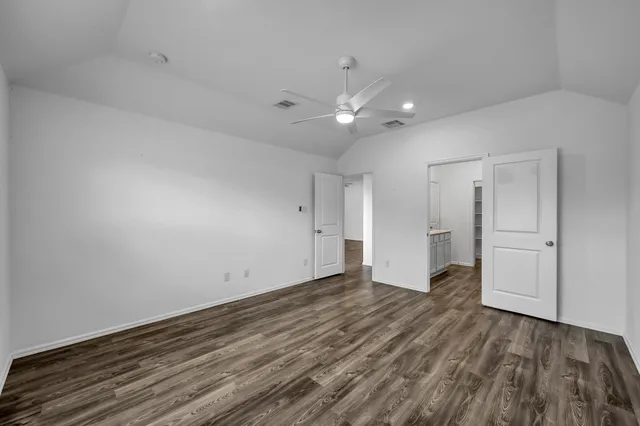 a spacious bathroom with a shower sink and a mirror