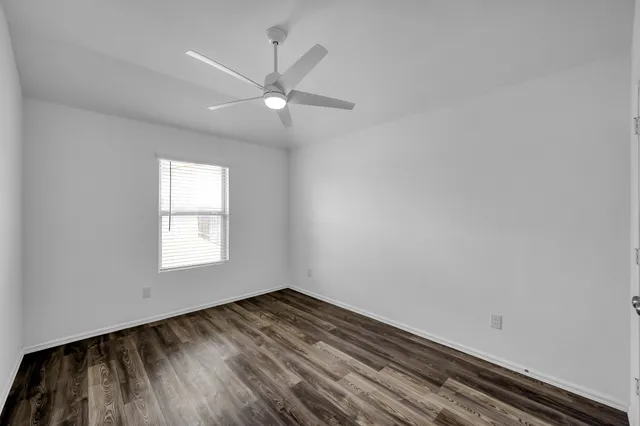 a view of a room with wooden floor and white walls