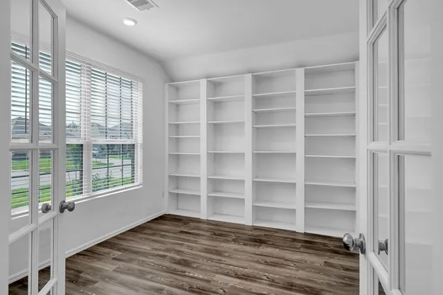 a view of a room with wooden floor and cabinet