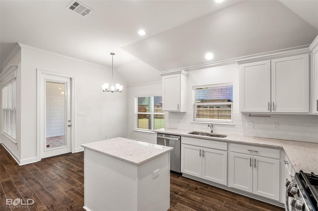 304 Prien Lk Loop Bossier City, LA 71111 - Photo 20 of 39 Kitchen featuring white shaker-style cabinetry, light-toned countertops, and wood-finish flooring