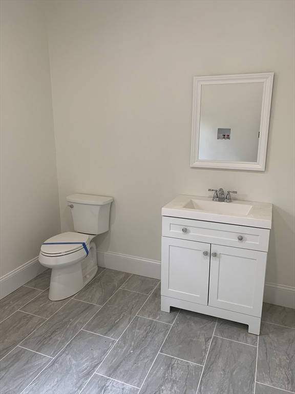 3 Baker Street Norton, MA 02766 - Photo 13 of 26 a spacious bathroom with a toilet sink and mirror