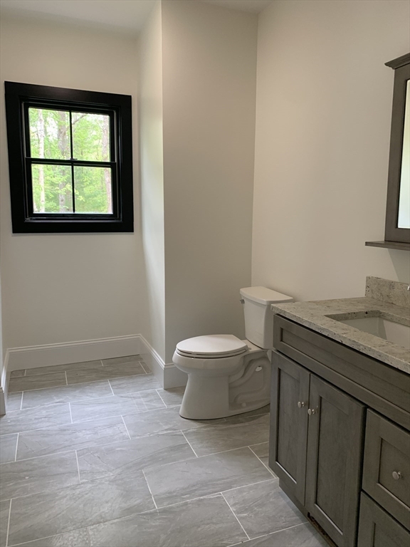 3 Baker Street Norton, MA 02766 - Photo 20 of 26 a bathroom with a granite countertop sink a toilet and a bathtub