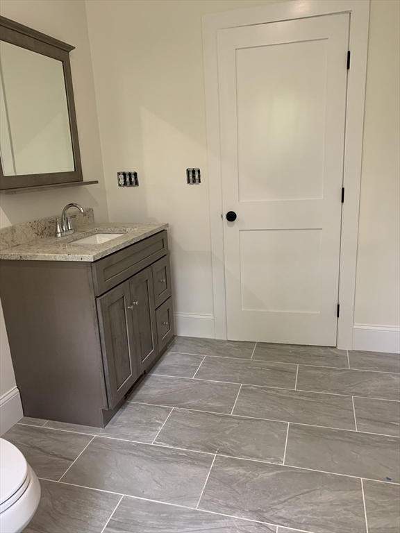 3 Baker Street Norton, MA 02766 - Photo 21 of 26 a bathroom with a sink a toilet and a mirror