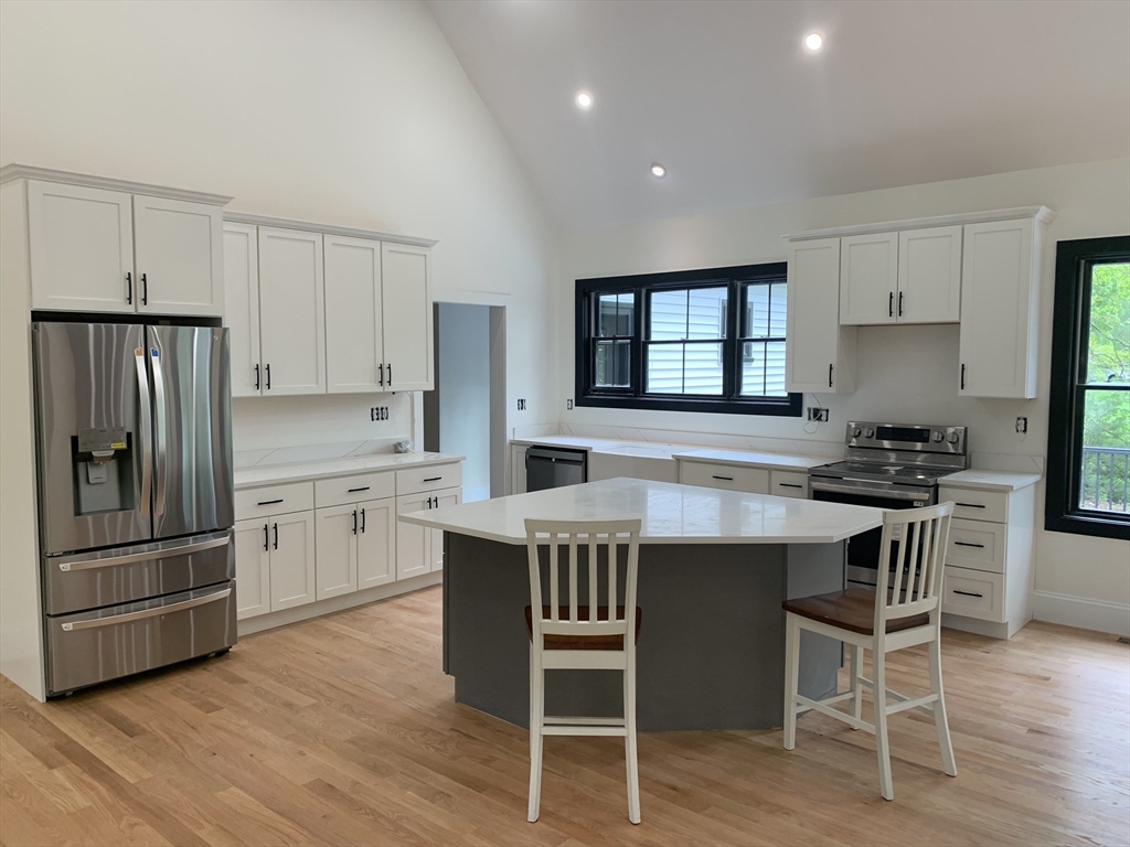 3 Baker Street Norton, MA 02766 - Photo 3 of 26 a kitchen with a table chairs refrigerator and cabinets
