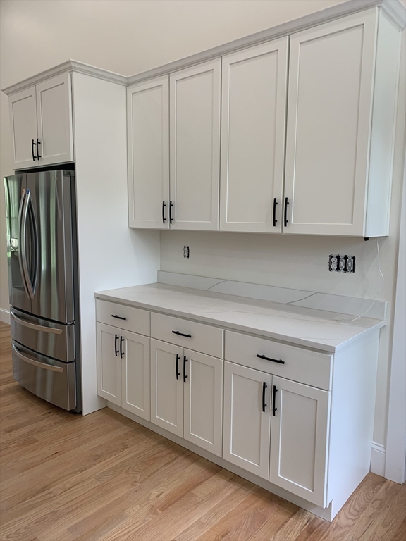 3 Baker Street Norton, MA 02766 - Photo 4 of 26 a kitchen with white cabinets and a refrigerator