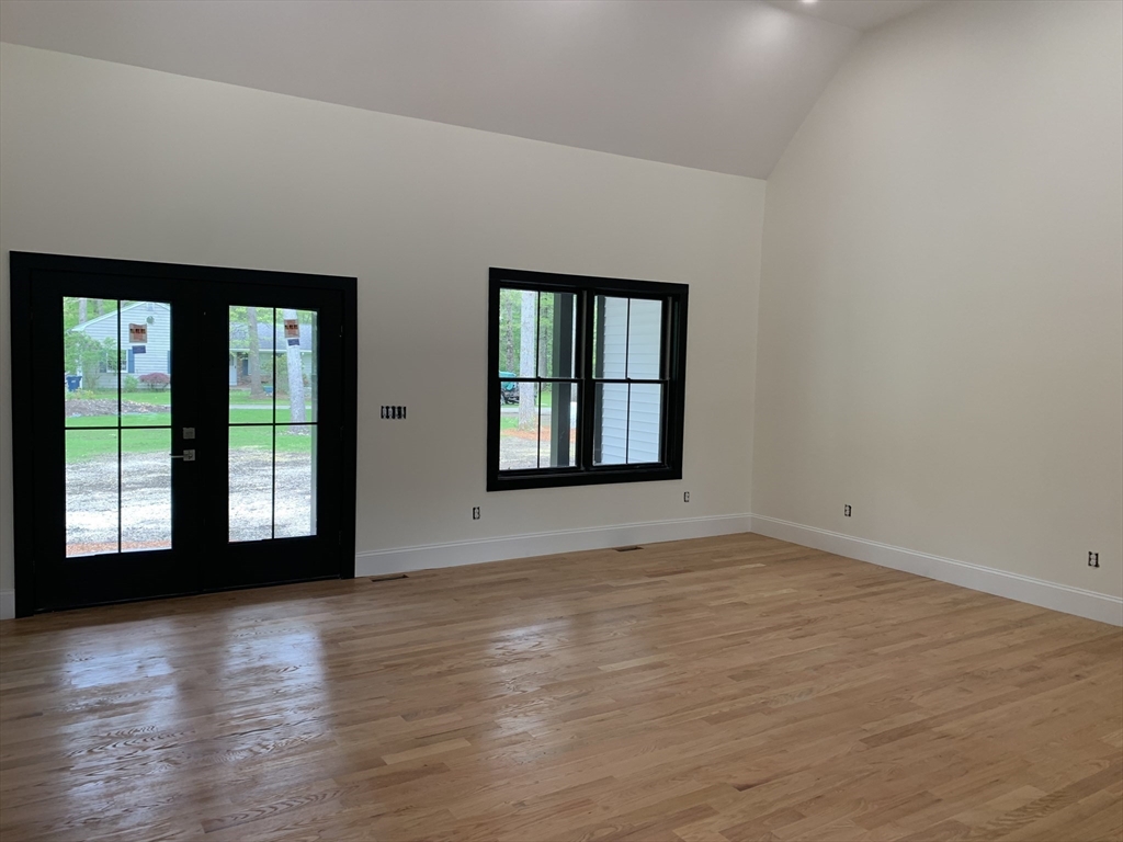 3 Baker Street Norton, MA 02766 - Photo 8 of 26 a view of an empty room with wooden floor and a window