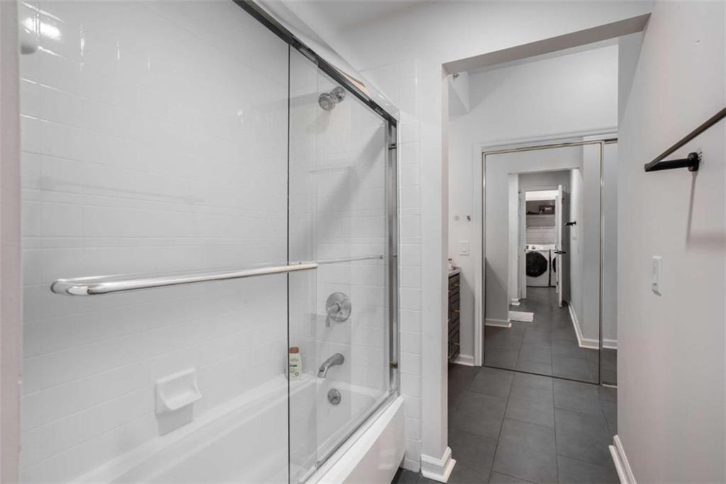 3475 Oak Valley Road Northeast, Unit 1630 Atlanta, GA 30326 - Photo 23 of 38 a bathroom with a bathtub and a shower
