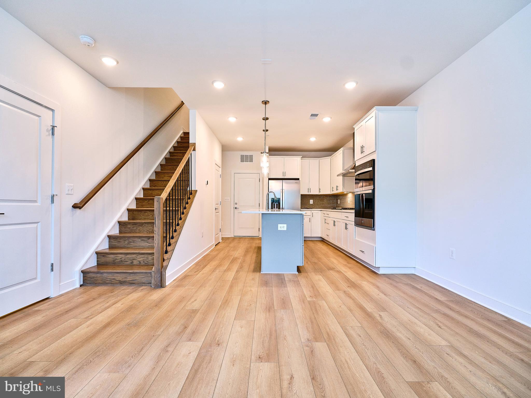 16076 Frederick Road Rockville, MD 20850 - Photo 11 of 30 a view of kitchen with cabinets and wooden floor