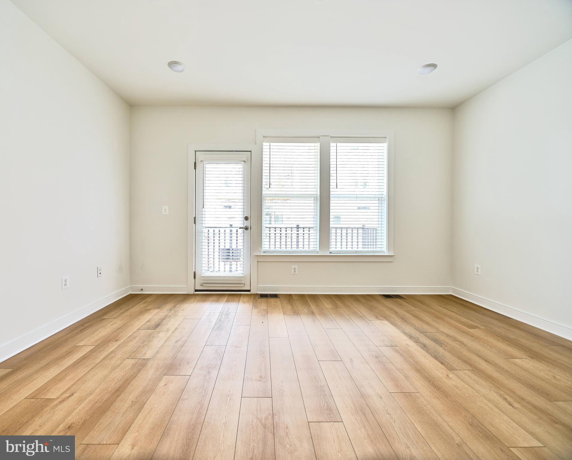 16076 Frederick Road Rockville, MD 20850 - Photo 14 of 30 a view of an empty room with wooden floor and a window