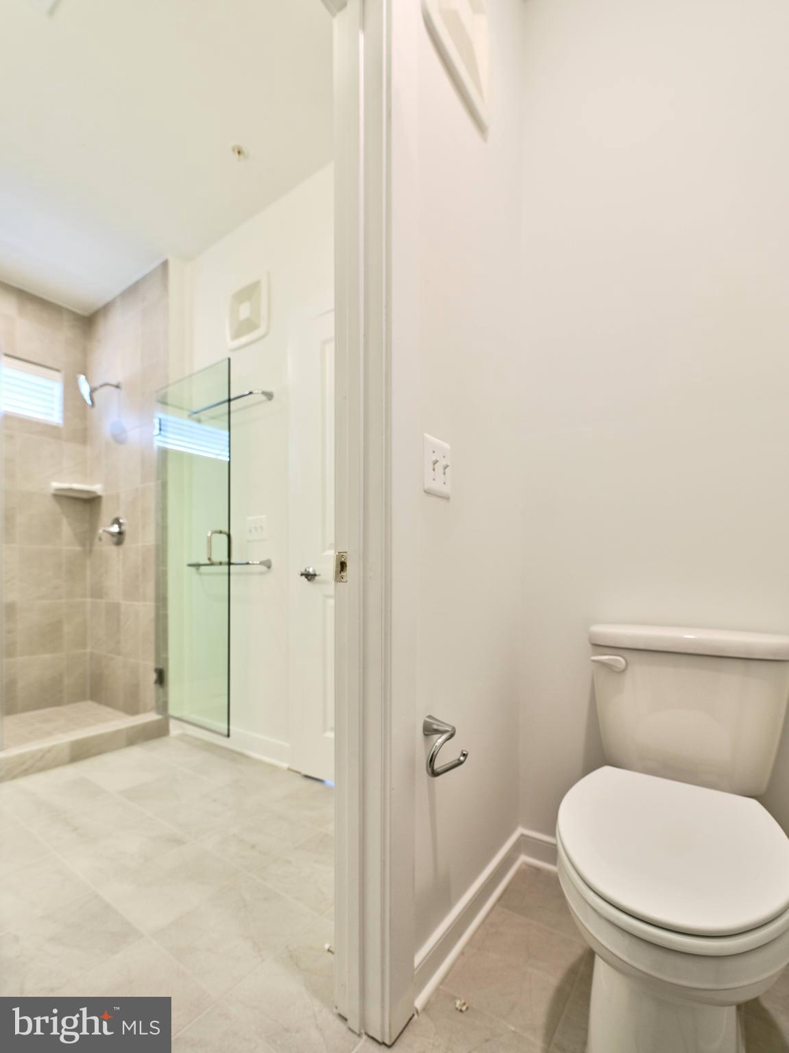16076 Frederick Road Rockville, MD 20850 - Photo 15 of 30 a bathroom with a toilet and a shower