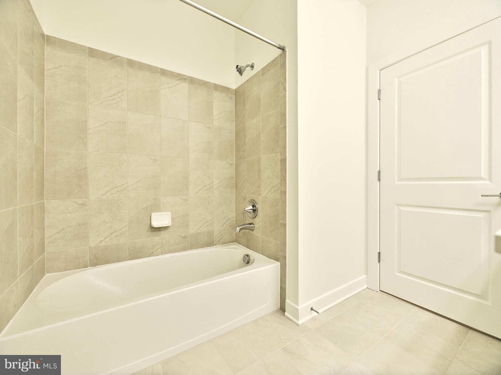 16076 Frederick Road Rockville, MD 20850 - Photo 25 of 30 a bathroom with a bathtub and a shower